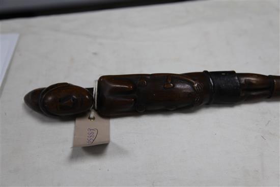 An early 20th century African carved wood walking stick, 37in.